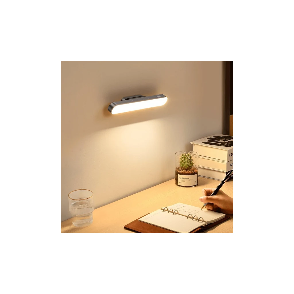 Baseus magnetic LED lamp lit in a warm nighttime ambience above a work table