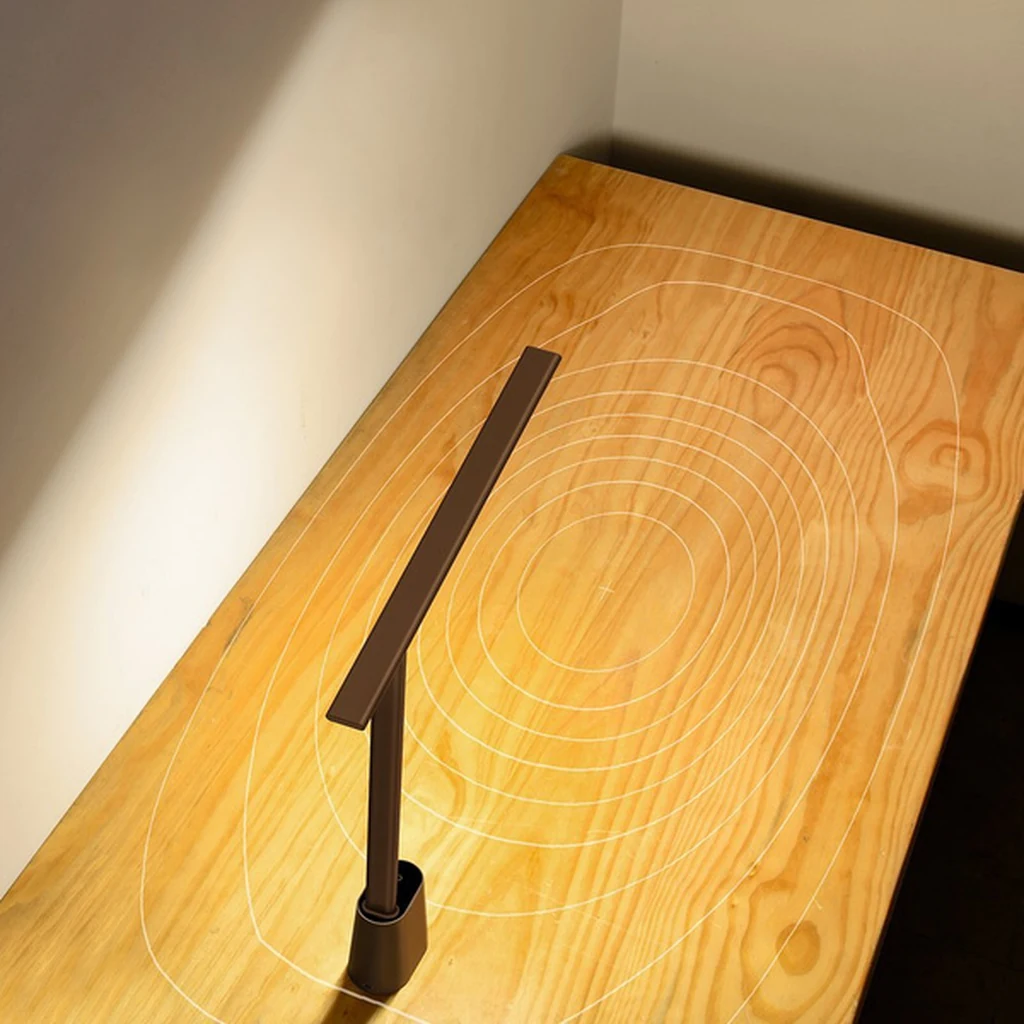Even light beam of the Baseus Smart Eye grey lamp cast over a wooden table